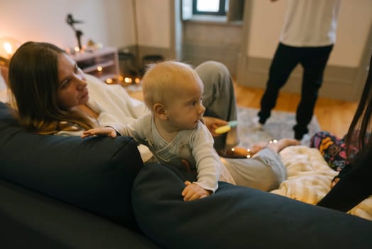 A heartwarming and cozy scene of a loving parent with their adorable baby, both enjoying quality time together at home