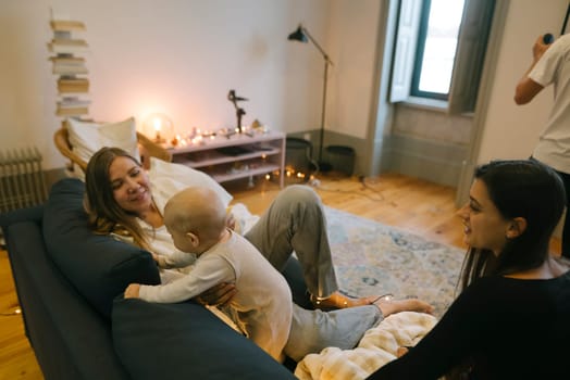 A warm and cozy family gathering is taking place in a modern living room, beautifully capturing love and joy