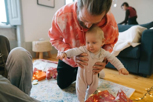 A heartwarming and delightful scene depicts a baby joyfully exploring and savoring a vibrant festive atmosphere