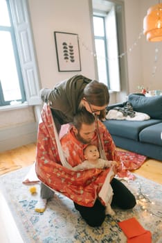 A joyful scene featuring a loving family engaged in playful interactions filled with warmth inside a stylish home
