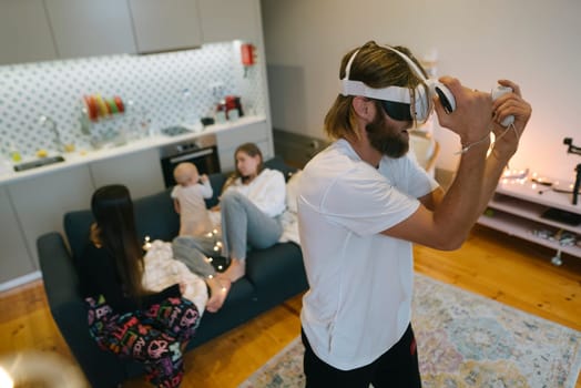 A cheerful family is having a great time enjoying a fun virtual reality gaming session in their cozy living room