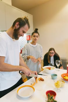 A vibrant kitchen scene with friends cooking together, showcasing teamwork and delicious food preparation.