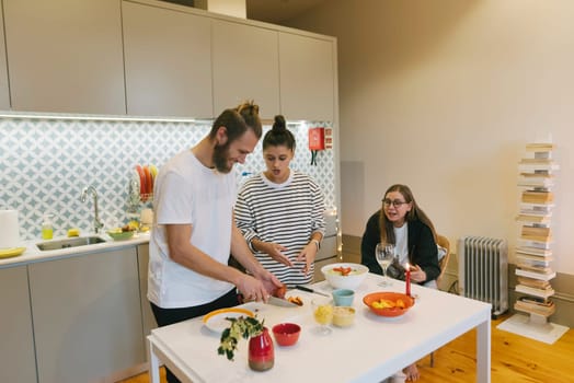 A lively and vibrant kitchen scene that beautifully showcases friends joyfully preparing a delicious meal together