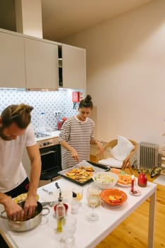 A lovely couple delights in cooking together inside a stylish kitchen that is filled with an array of fresh ingredients