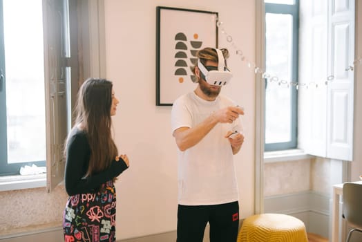 Two individuals interact with each other during an immersive virtual reality session set in a stylish environment