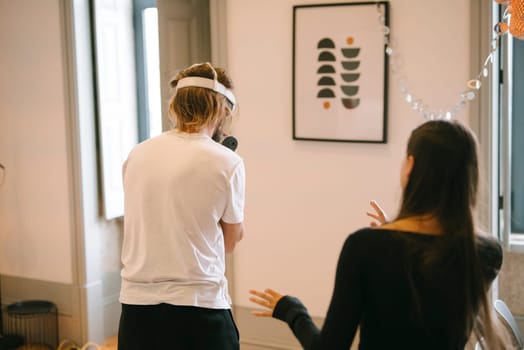Two individuals engaged in a creative moment indoors, beautifully showcasing collaboration, motivation, and inspiration