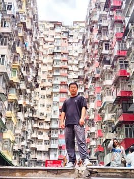 Hong Kong, China - April 06, 2024 - Visitors gather around the famous monster apartment building in Hong Kong, marveling at its unique design and height. The monster House.