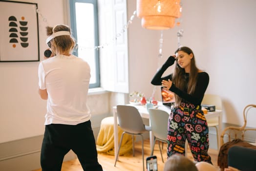 A vibrant group of friends joyfully celebrates moments together in a modern living space with colorful decor