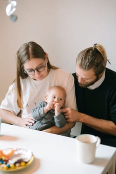 A heartfelt moment with loving parents cherishing time with their baby at home, highlighting deep love and connection