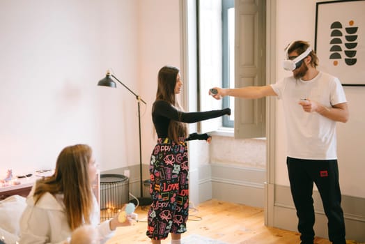 Friends happily enjoying a virtual reality experience together in a cozy and comfortable indoor setting