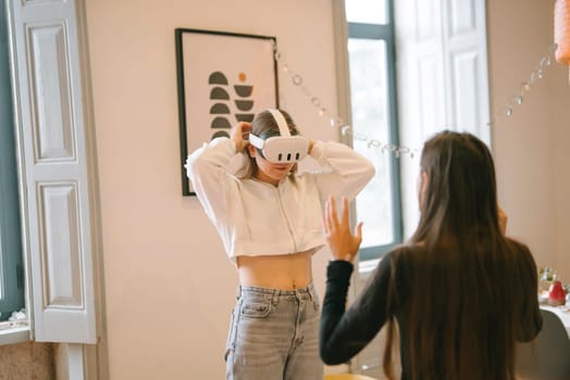 Two friends enjoy an immersive virtual reality experience while wearing VR headsets in their cozy home environment