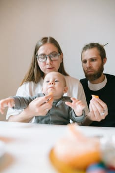 A loving family enjoys a delightful snack time together, showcasing strong bonding and sincere warmth among them
