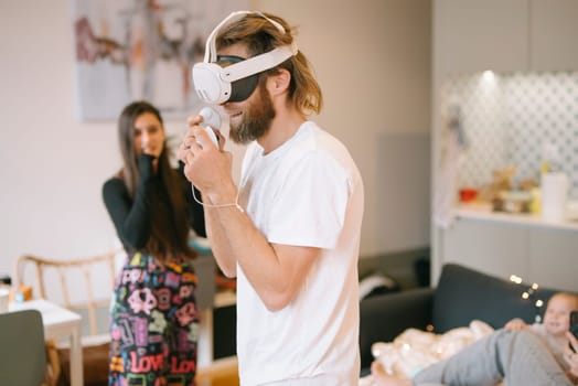 A vibrant and cool VR gaming scene where friends are joyfully enjoying immersive technology in a modern apartment
