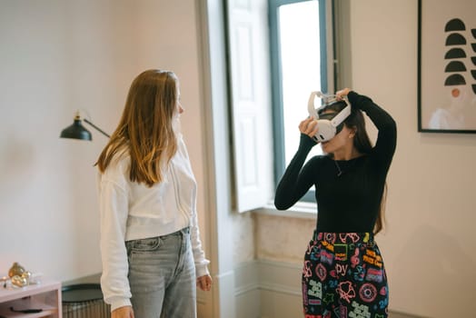 Two women explore virtual reality in a modern room, beautifully showcasing technology and friendship