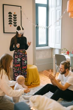 A family enjoys a delightful and engaging virtual reality playtime experience with their baby in a cozy living space