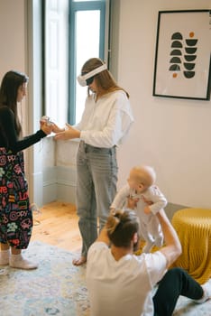 A family enjoys quality time together in virtual reality while caring for their stylishly designed baby