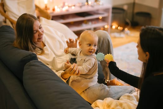 A heartwarming moment of laughter and playfulness between a baby and their loving family in a cozy home