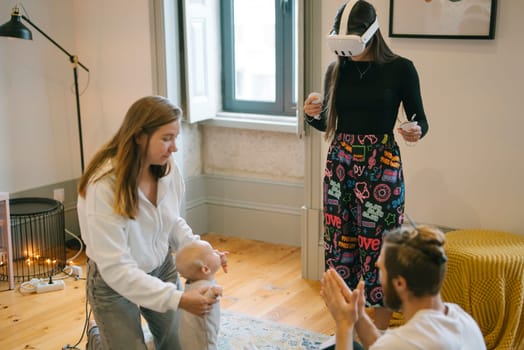 A happy family enjoys captivating virtual reality experiences while caring for their baby in a cozy home