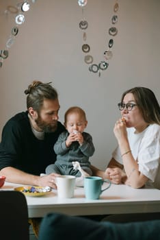 A loving family gathers together, sharing quality time filled with snacks and laughter in their cozy home