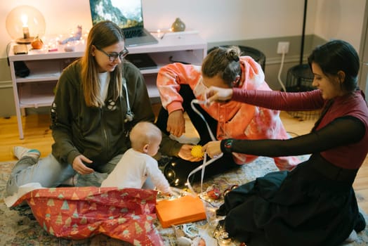 In a closeknit family, they joyfully unwrap colorful gifts together, creating and sharing heartwarming moments