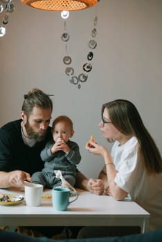 A warm and cozy family scene with affectionate parents enjoying breakfast together with their beloved child