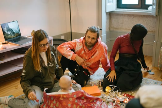 A wonderfully cozy gathering of friends with a baby in a stylish indoor setting, joyfully sharing moments together