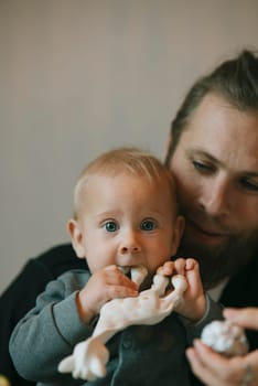 A heartwarming scene of a devoted father lovingly and playfully interacting with his curious little baby