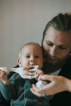A delightful and playful interaction between a loving father and his baby featuring a captivating eyecatching prop