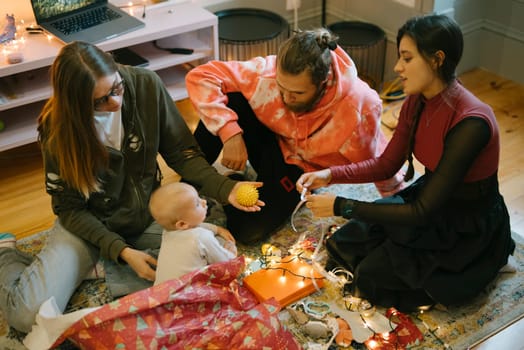 A warm gathering of friends around a precious baby, sharing joyful and festive moments of happiness