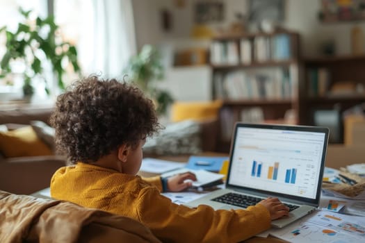 A young child explores online learning on a laptop surrounded by charts and papers in a cozy indoor workspace. The scene captures the joy of education and creativity.