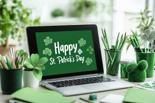 A laptop screen with a green background and a green St. Patrick's Day message. The laptop is on a desk with green pens, pencils, and a potted plant