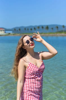 Bright blond young woman standing in sea in summer