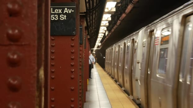 New York City, United States - 30 Aug 2023: Subway station, underground metropolitan platform sign. Metro train, railway public transport. Text signboard: Lexington Avenue. Lex Av. Midtown Manhattan.