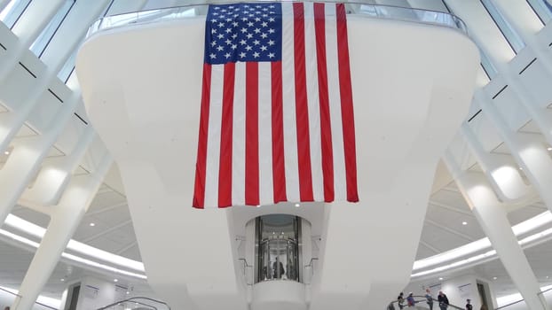 New York City, United States - 10 Sept 2023: World Trade Center Oculus architecture. Manhattan Downtown Financial District, USA. September 11 remembrance, large memorial american flag. 911 Patriot day