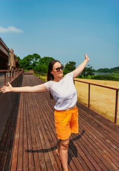 36 years old russian woman in orange shorts and sunglasses enjoying the summer day