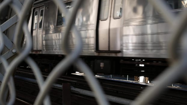 New York City, United States - 14 Sept 2023: Manhattan Bridge to Brooklyn Dumbo. American subway metro train from pedestrian path. Public railway transport. Railroad traffic and architecture in USA.