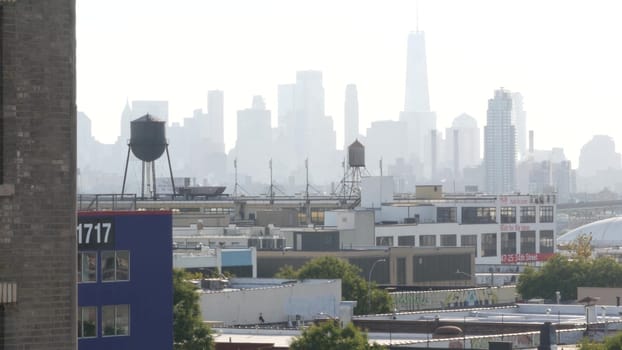 New York City, United States - 3 Sept 2023: Manhattan downtown financial district skyline cityscape. World Trade Center skyscraper. Rooftop water tower, tank on roof. Industrial buildings in Queens.