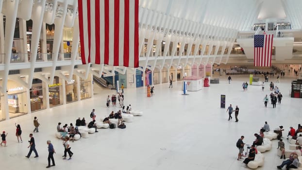 New York City, United States - 10 Sept 2023: World Trade Center Oculus transport hub architecture. Manhattan Downtown Financial District, USA urban life. People. September 11 remembrance american flag