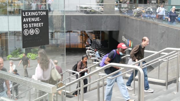 New York City, United States - 11 Sept 2023: Manhattan Midtown Lexington avenue, United States. People pedestrian exit underground subway station, stairs on 53 street, urban USA. Metro entrance sign.