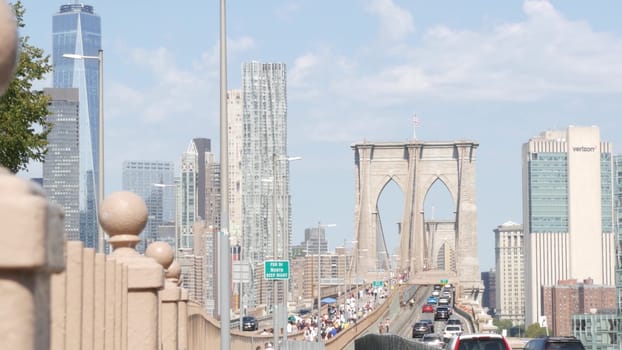 New York City, United States - 3 Sept 2023: Cars on Brooklyn Bridge from Manhattan downtown. Financial district skyline cityscape. Road traffic, people, architecture. World Trade Center skyscraper.