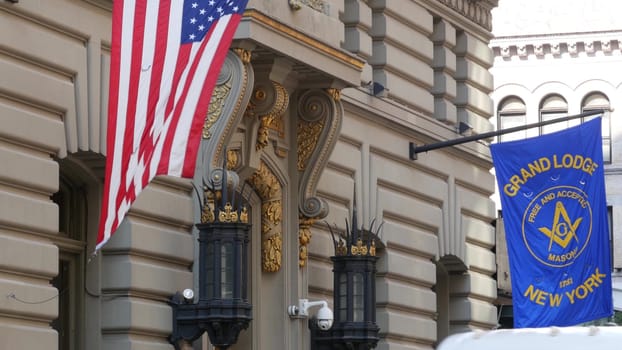 New York City, United States - 6 Sept 2023: Grand Lodge of Masons building facade, Manhattan street. Freemasons headquarters architecture. Masonry organization in NYC, USA. Masonic Hall exterior. Flag