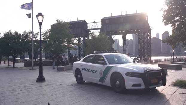New York City, United States - 31 Aug 2023: Police patrol car, Long Island, USA 911. American cop auto, Hunters Point, Queens street. Waterfront Gantry Plaza State Park, young people, teens, teenagers