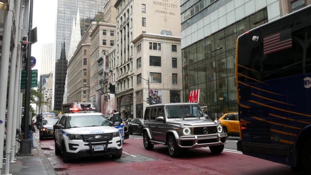 New York City, United States - 13 Sept 2023: Police patrol car, USA NYPD officer, 911 vehicle on Manhattan Midtown street. American cop auto siren light on Fifth 5 avenue. Urban road traffic jam. HM.