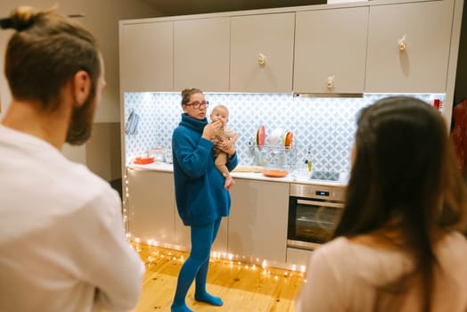 A cherished warm moment of family bonding takes place with a baby in a stylish and inviting kitchen setting