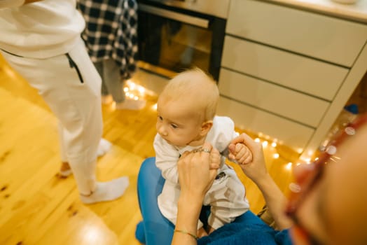 A heartwarming family moment unfolds as a baby joyfully interacts in a cozy and inviting kitchen environment