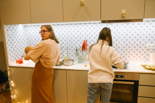 In a stylish kitchen, two women cook together, blending domestic harmony with modern design elements