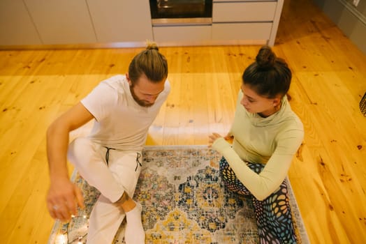 A couple is engaging in mindfulness practices on a soft, plush rug found in their cozy, lovefilled home space