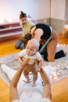 In a serene and wellnessfocused setting, a heartwarming scene unfolds as parents bond with their cherished babies