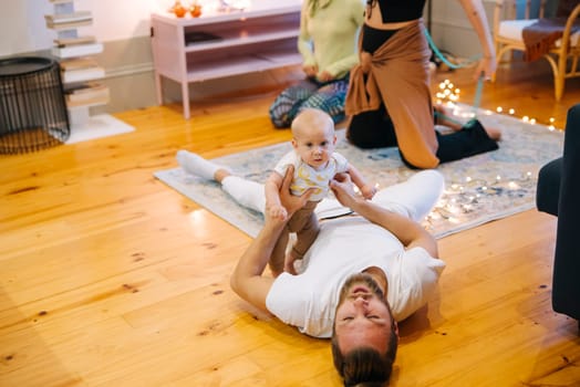 A joyful family happily plays together indoors, beautifully showcasing their love, connection, and happiness