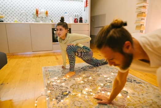 A cheerful family enjoys a fun workout at home, filled with laughter and creativity, fostering connection